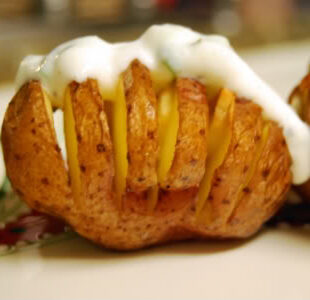 Garlic Hasselback Potatoes with Herbed Sour Cream